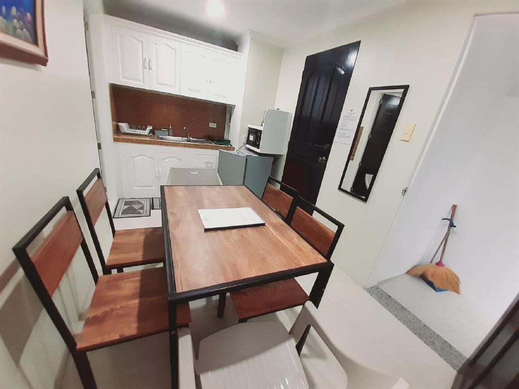 a dining room table and chairs in a kitchen at Avana Hills Boracay Prime Horizon Suite 103 in Boracay