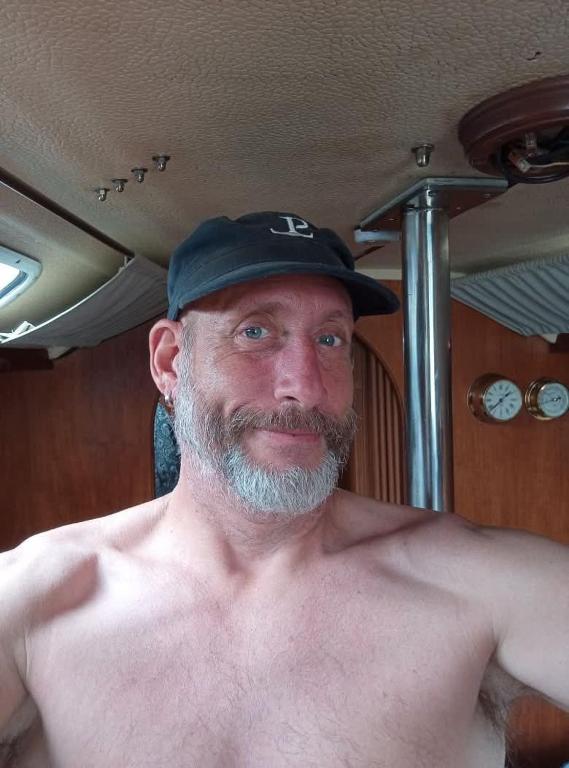 a shirtless man wearing a black hat at Bakarvågen 2 in Bakarvågen