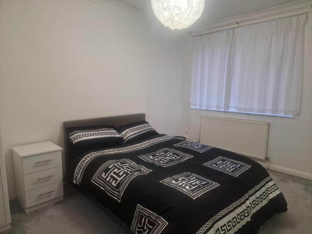 a bedroom with a bed with two pillows and a window at Oakfield Gardens NY in Edmonton