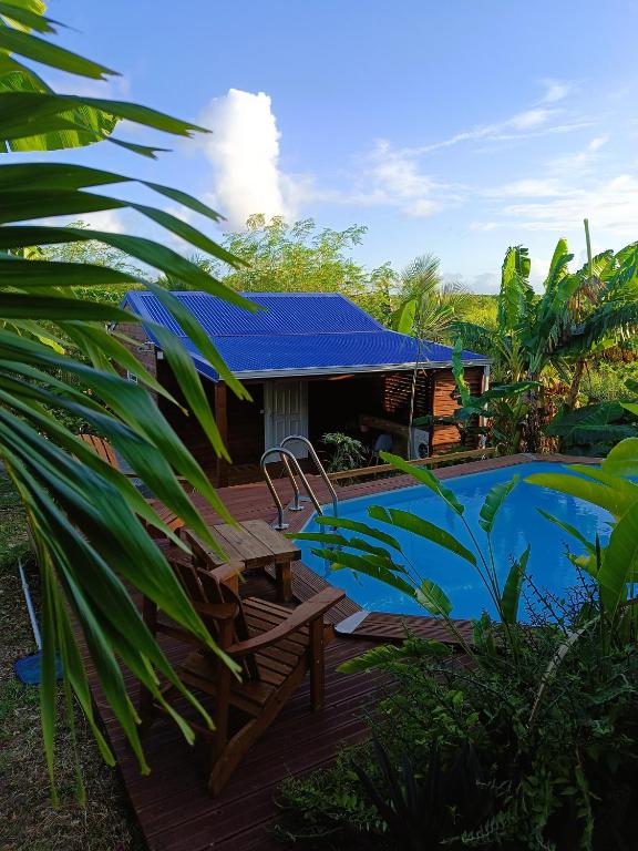 a resort with a swimming pool and a house at Gites kaz à klemence - bungalow Colibris in Anse-Bertrand