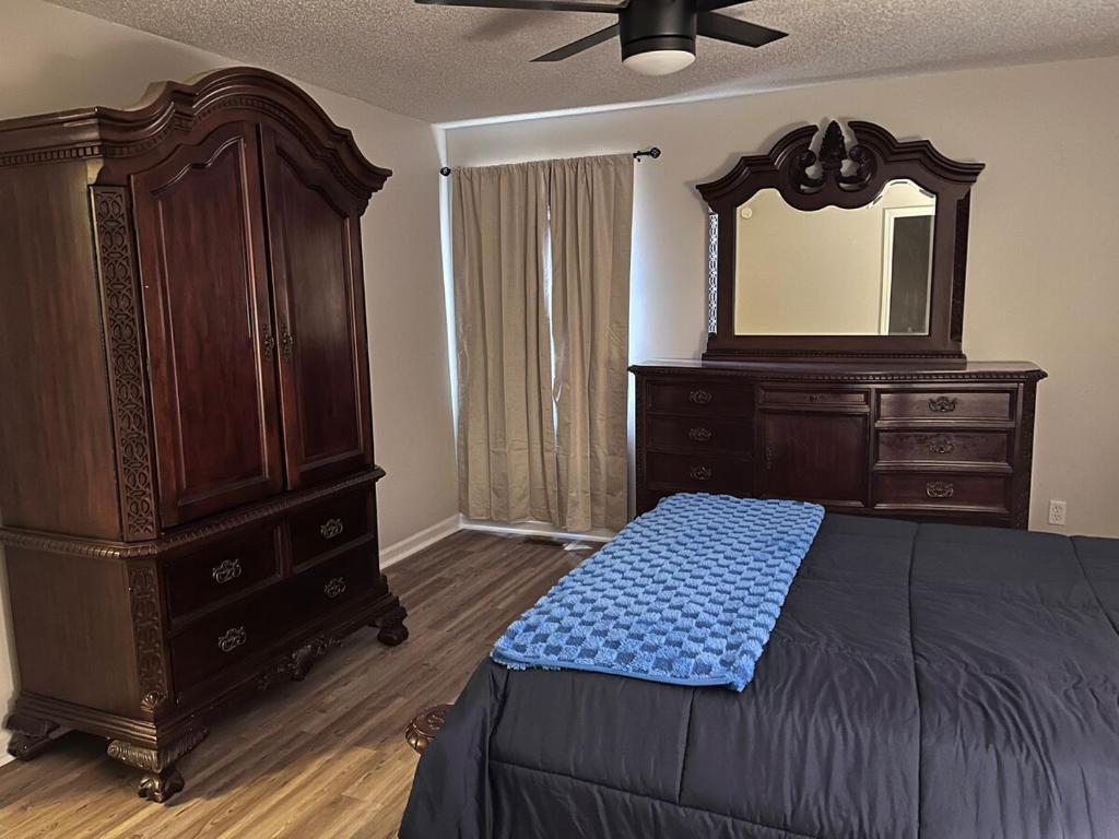 a bedroom with a bed and a dresser and a mirror at Your special Stay in Birmingham