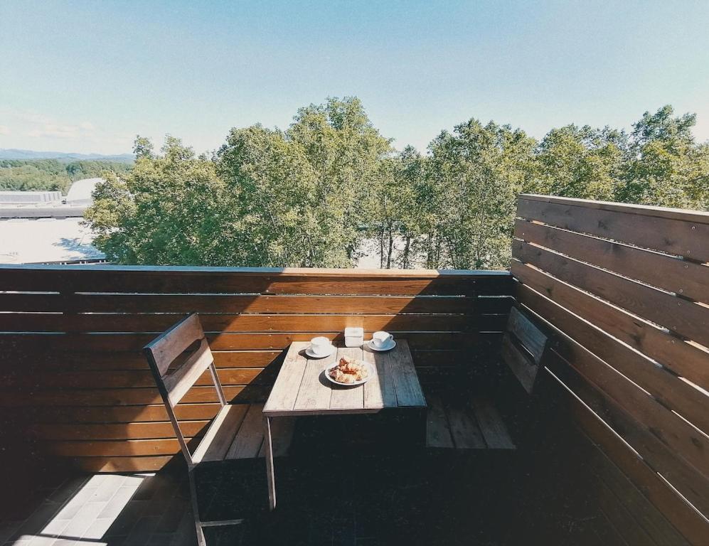 a balcony with a table with a plate of food on it at Central 2 bedroom apartment with terrace in Girona