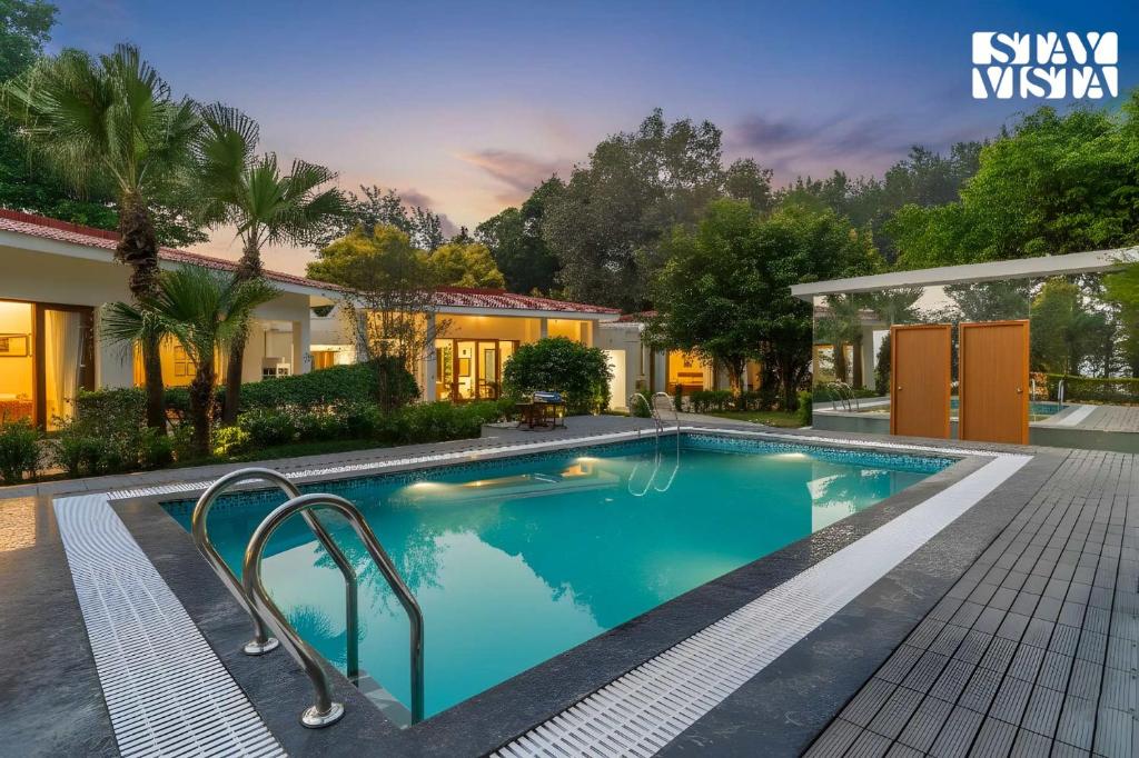 デヘラードゥーンにあるStayVista at Everdale with Heated Pool, Pet friendly, Bathtubの家の前のプール