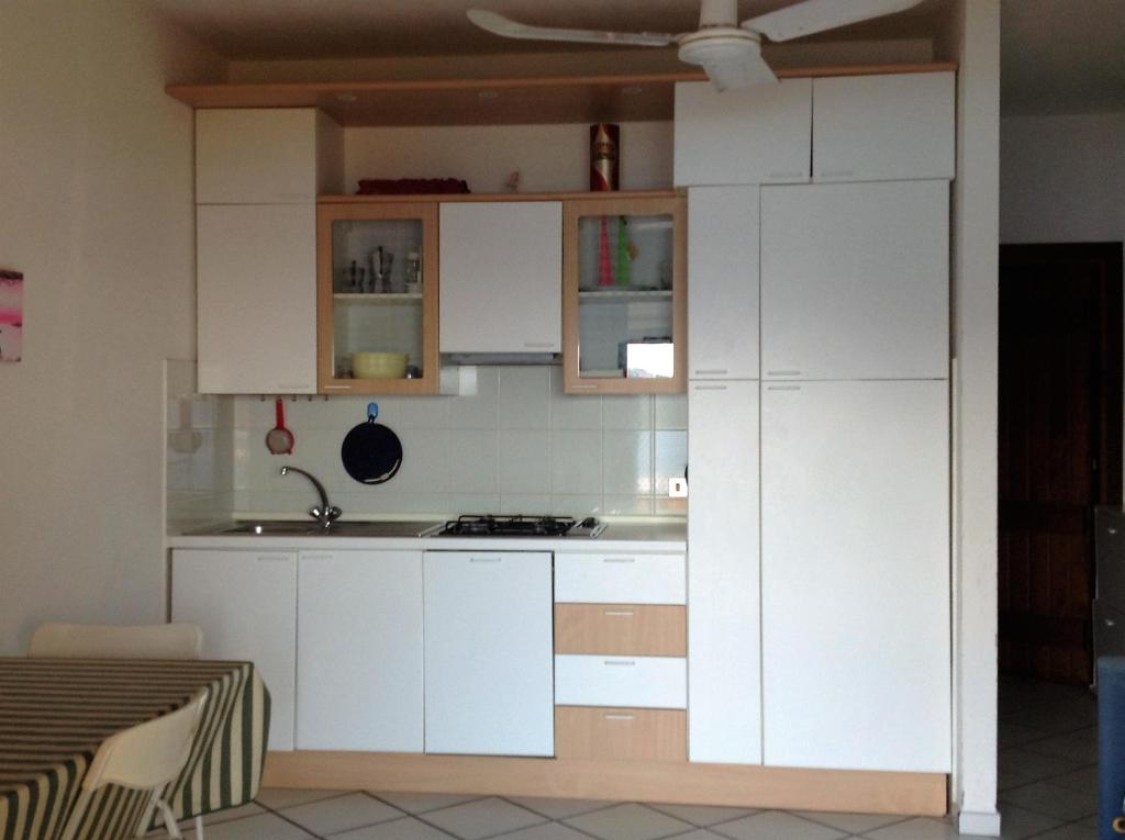 a kitchen with white cabinets and a sink at Casa Debby in Palau