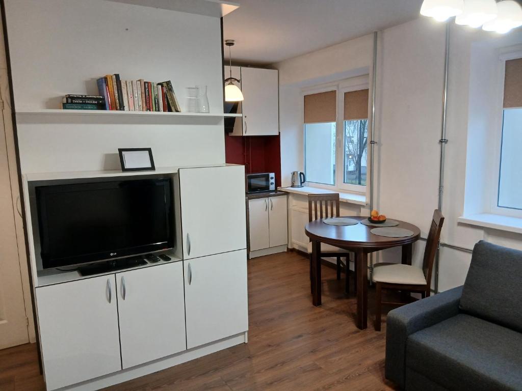 a living room with a television and a dining room table at Alytus Studio 45 in Alytus