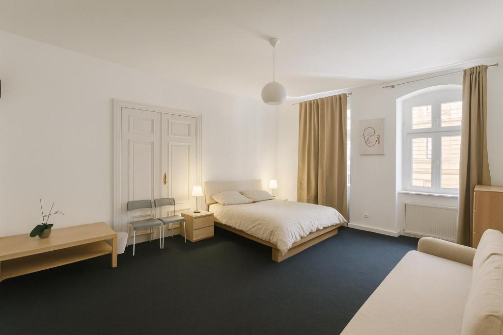 a hotel room with a bed and a window at Power Nap by Harmonia 24h self check-in in Poznań