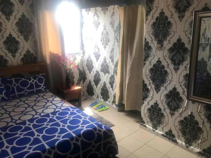 Postel nebo postele na pokoji v ubytování Chambre Ydé Bastos