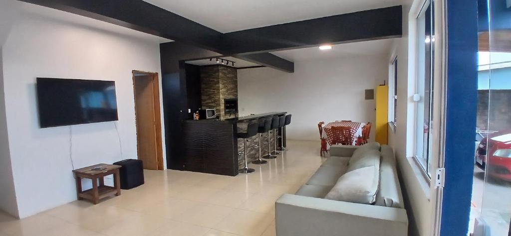 a living room with a couch and a fireplace at Sobrado de 3 quartos in Capão da Canoa