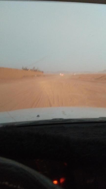 a view of a desert from the inside of a car at Mars rum camp in Wadi Rum