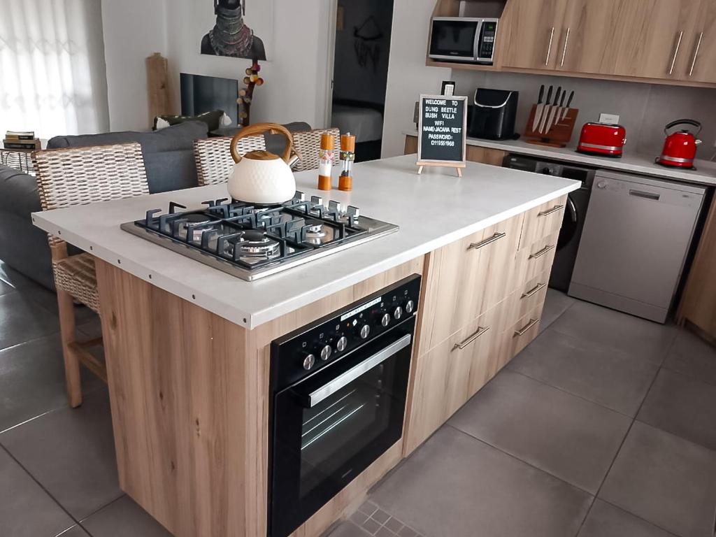 a kitchen with a stove top on a counter at Dung Beetle Bush Villa in Marloth Park