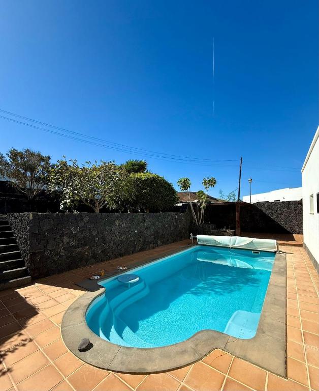 a swimming pool in the middle of a yard at Villa Marée La Costa in La Costa