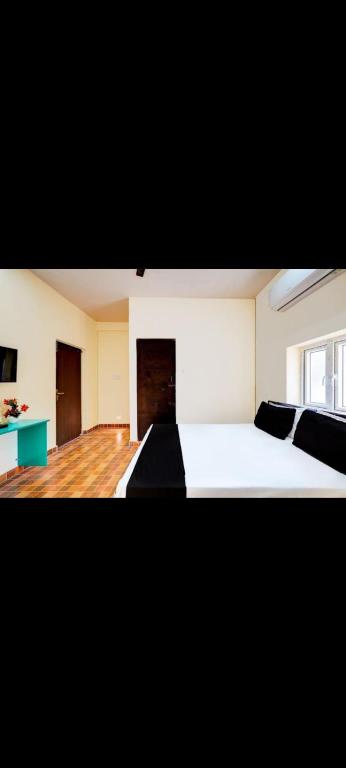 a large bedroom with two beds and a window at Hotel RR palace iyyapanthangal near Ramachandra hospital in Chennai