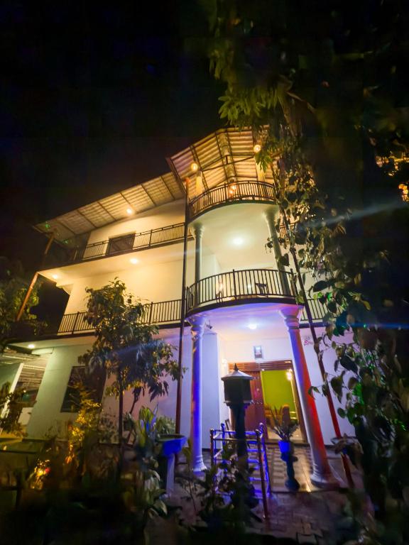 a building with a lit up front at night at JAMI River Side Hotel & Yala Safari Place in Tissamaharama