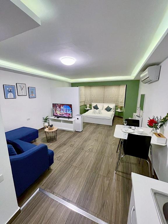 a living room with a blue couch and a tv at Cozy room at Hillside2 Condo in Chiang Mai