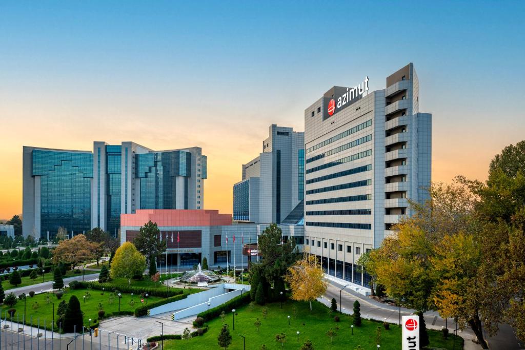 a group of tall buildings in a city at AZIMUT Grand Hotel Tashkent in Tashkent