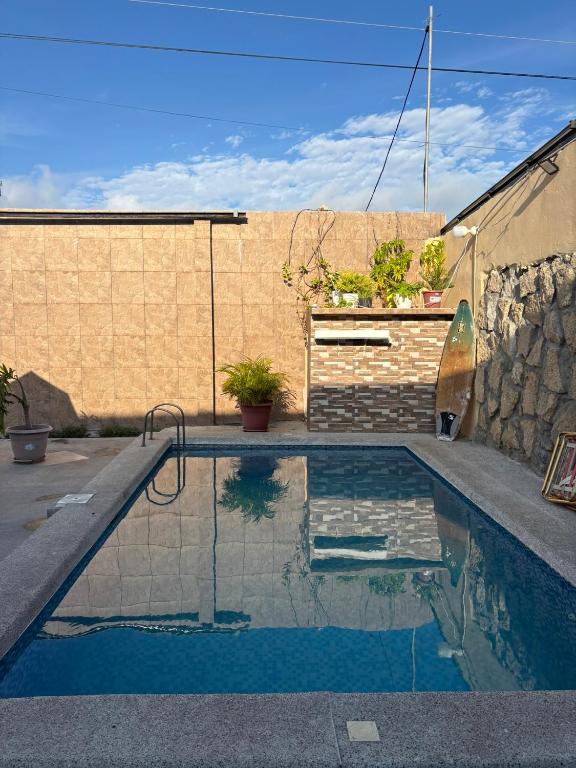 a swimming pool in front of a brick wall at Casa con Piscina Privada in Salinas