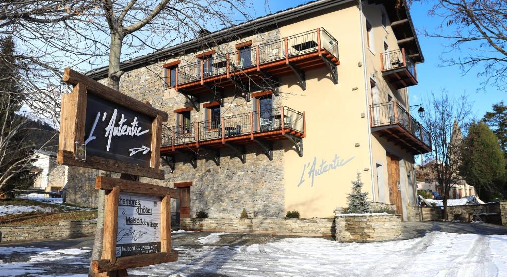 a building with balconies and a sign in the snow at L'Autentic in Aussois