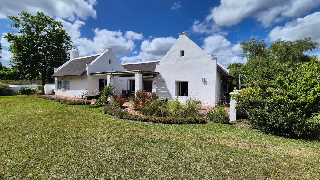 a white house with a yard at Coppull Private Nature Reserve in Stanford