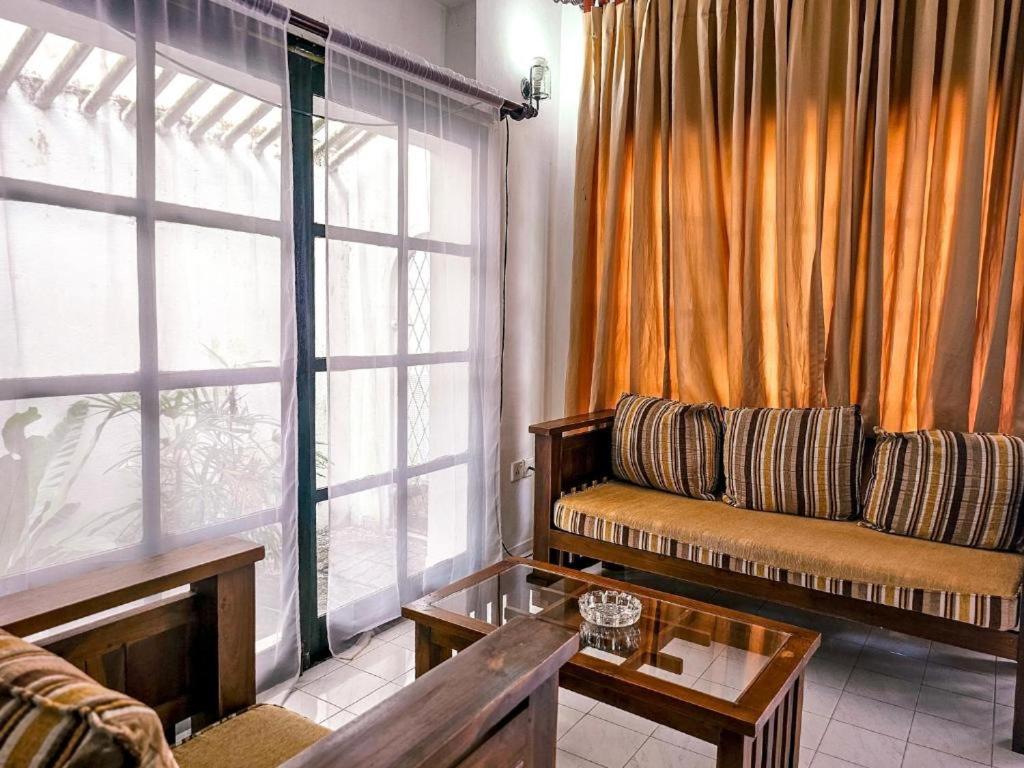 a living room with a couch and a table at The Colombo House in Battaramulla