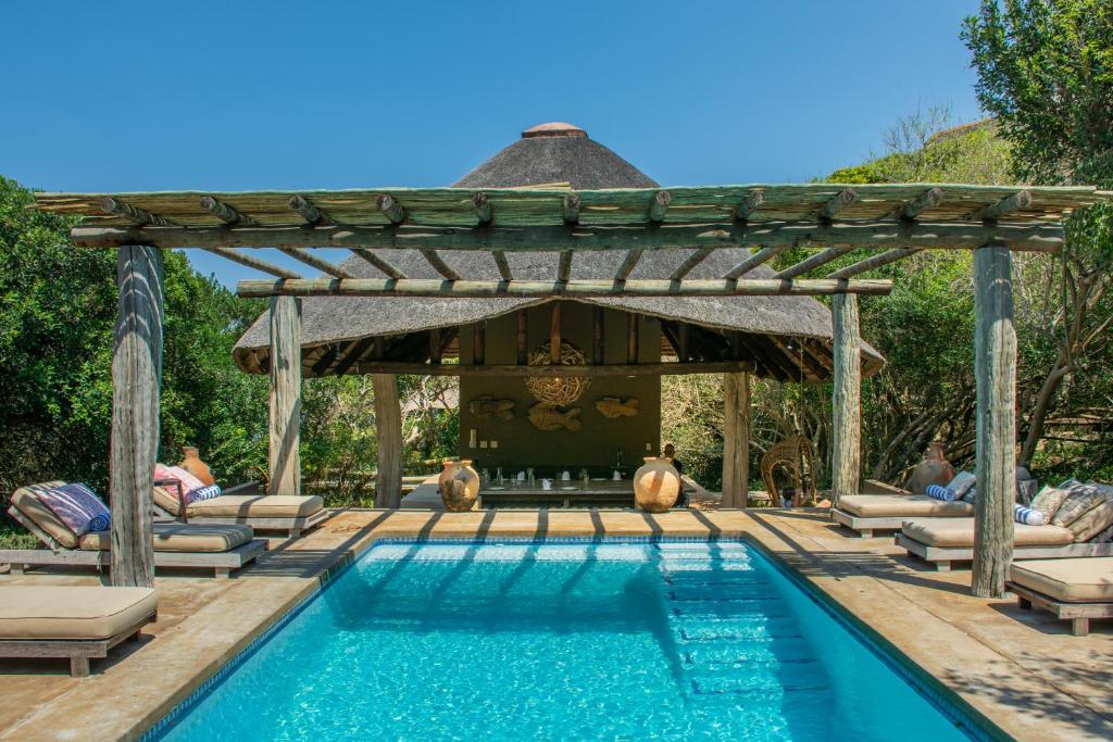 a swimming pool with a pergola and a swimming poolvisor at Monarch Beach Villa in Cimbene