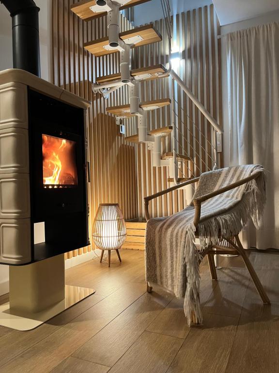 ein Wohnzimmer mit Kamin und Sessel in der Unterkunft Warmiński Sad in Olsztyn