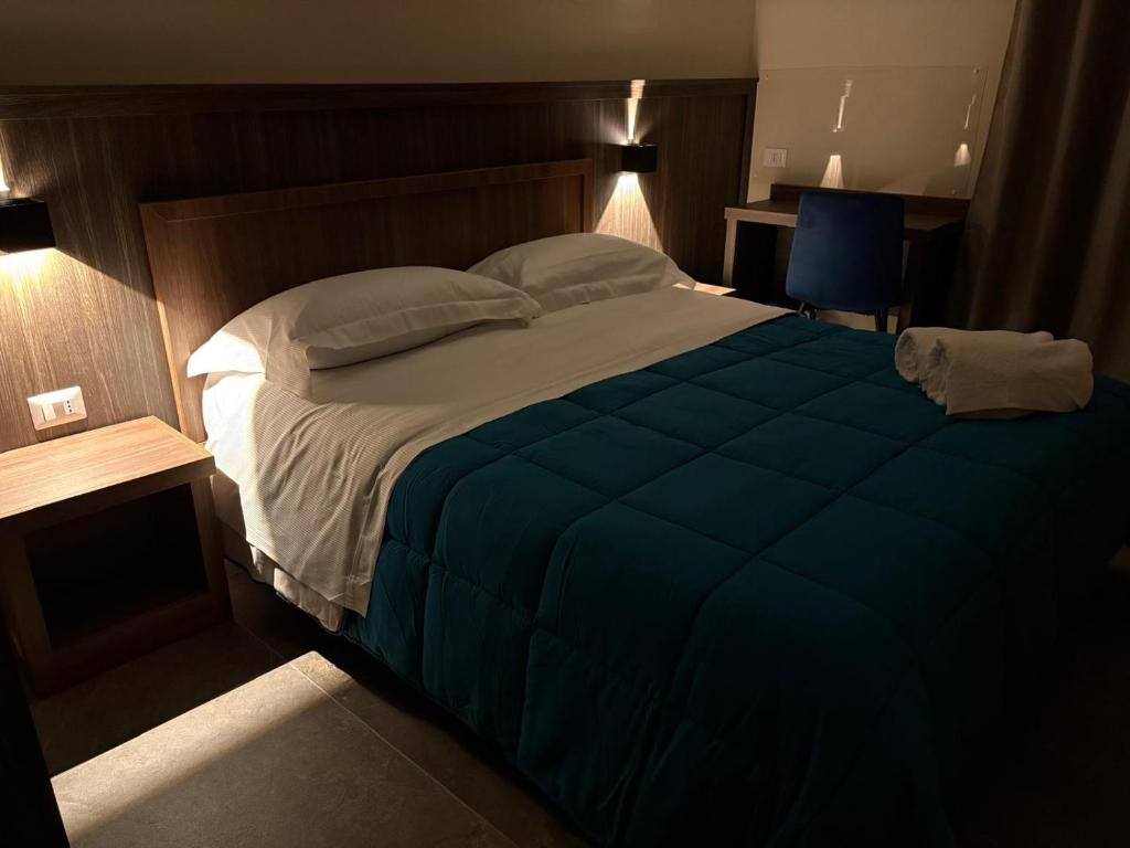 a bedroom with a large bed with a blue blanket at Andrea House in Naples