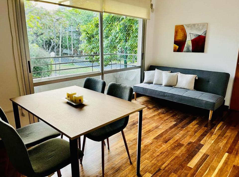 a living room with a table and a couch at Tempo Apart in La Plata