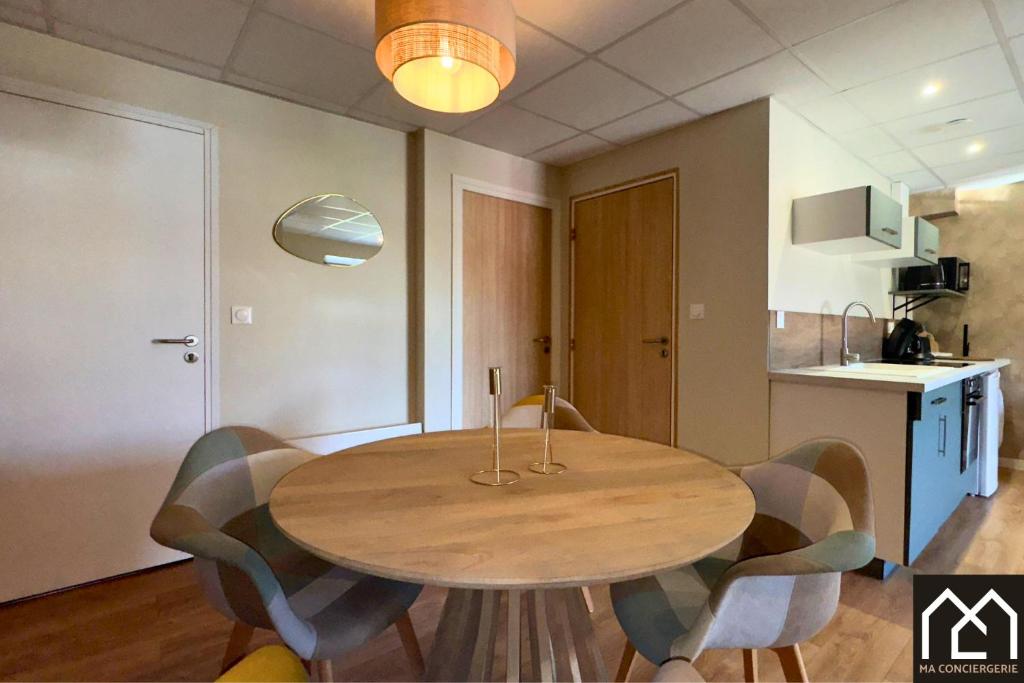 a wooden table in a kitchen with chairs around it at Retour de plage in Le Portel