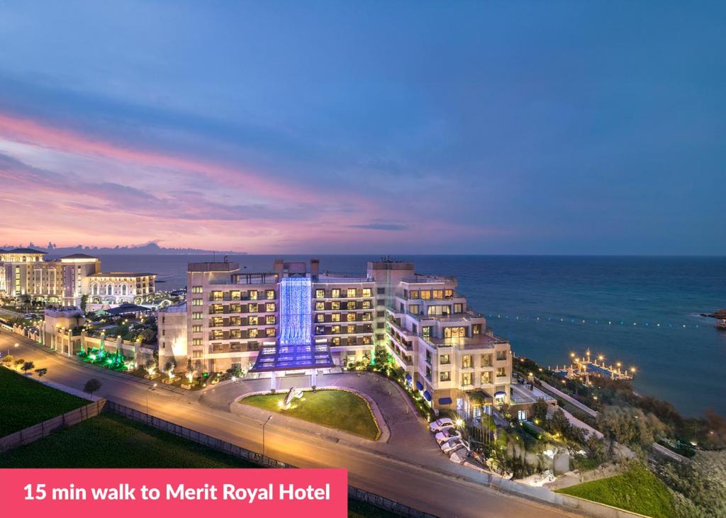 a night view of a hotel and the ocean at Crystal Villa walk by Merit Casinos By HolidayKeys in Kyrenia