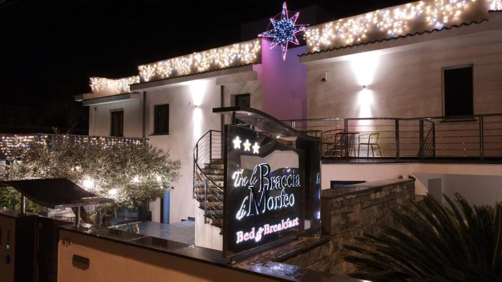 a sign on the side of a building with lights at Tra Le Braccia di Morfeo in Terrasini