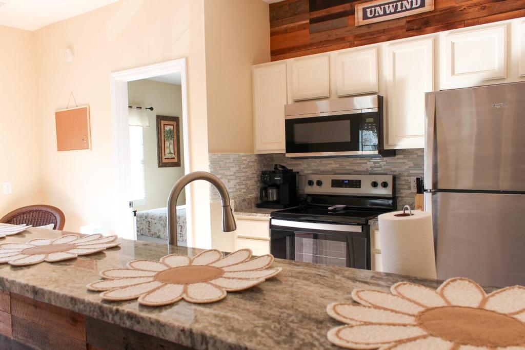 a kitchen with a counter with two plates on it at Royal Jr. Suite in Sunset Beach