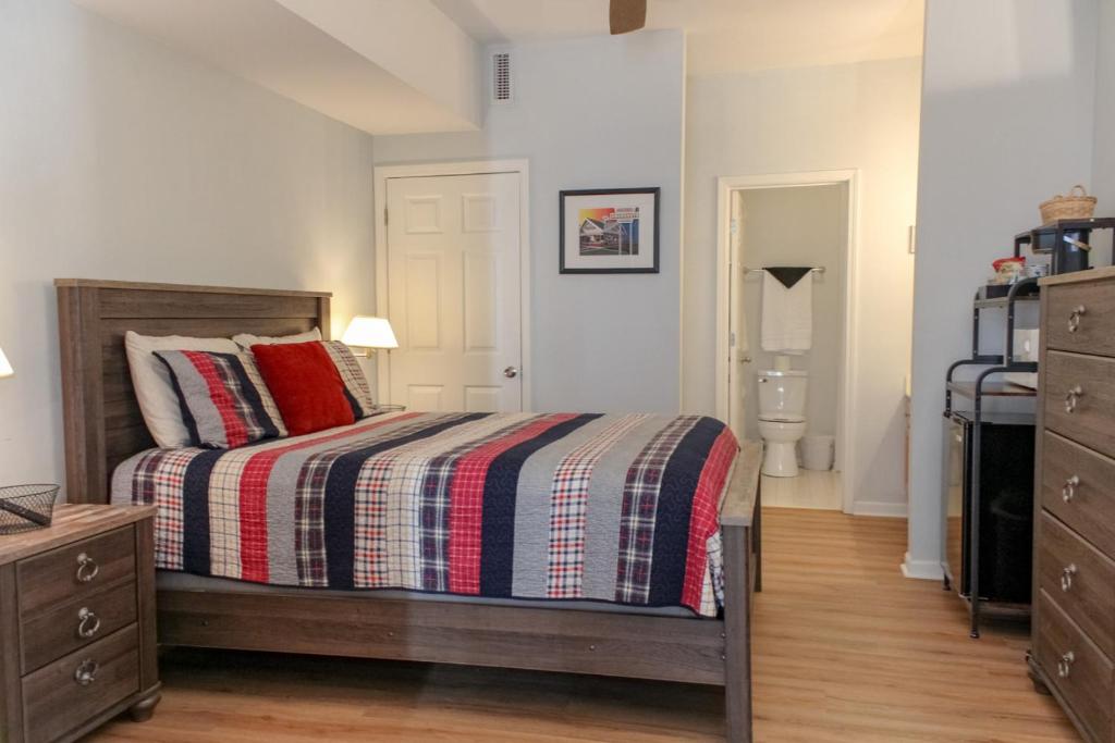 a bedroom with a bed with a striped comforter at The Suite at 205 Royal Poste Rd in Sunset Beach