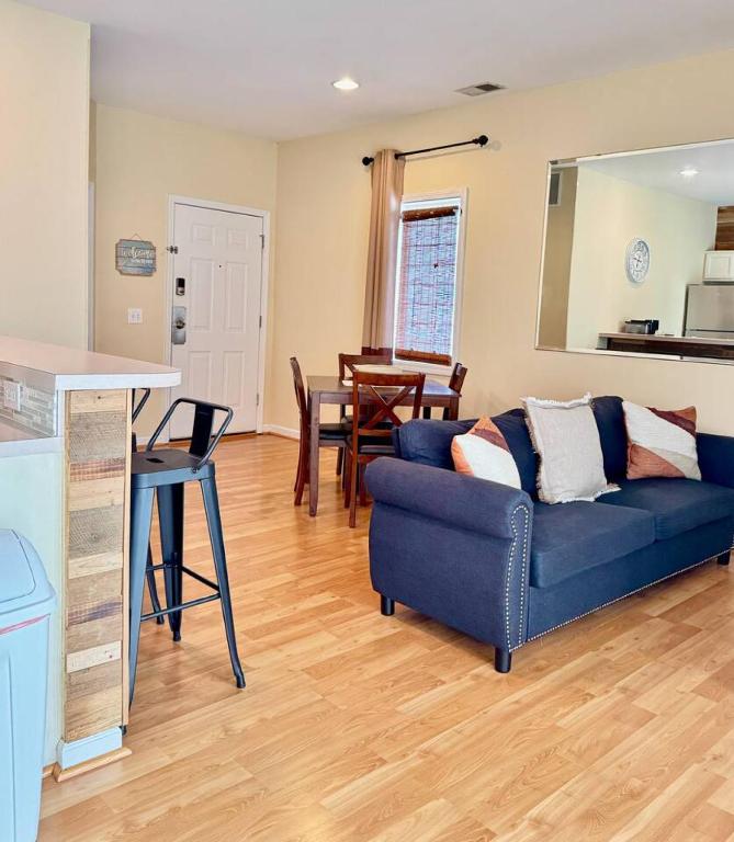 a living room with a blue couch and a table at Royal Villa in Sunset Beach