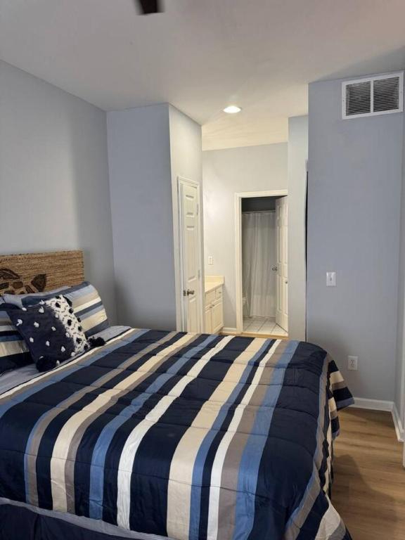 a bedroom with a blue and white striped bed at The Villa at 125 Royal Poste Rd in Sunset Beach