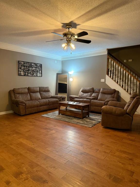 a living room with two couches and a ceiling fan at Marion Getaway in Marion