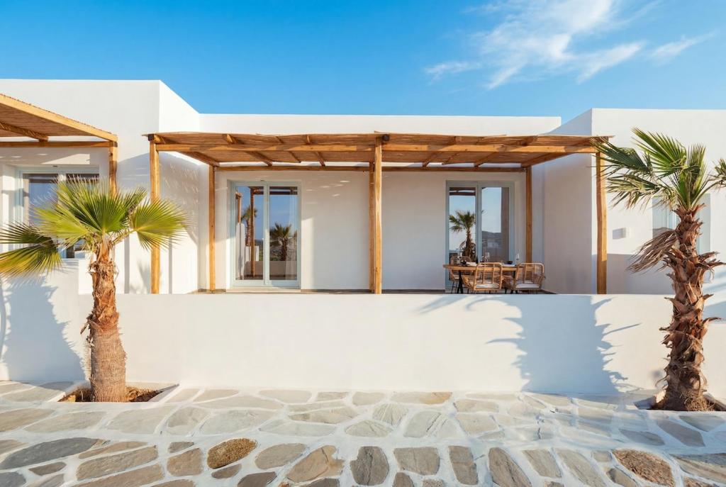 two palm trees in front of a house at Kyma Paros Apartments 2 