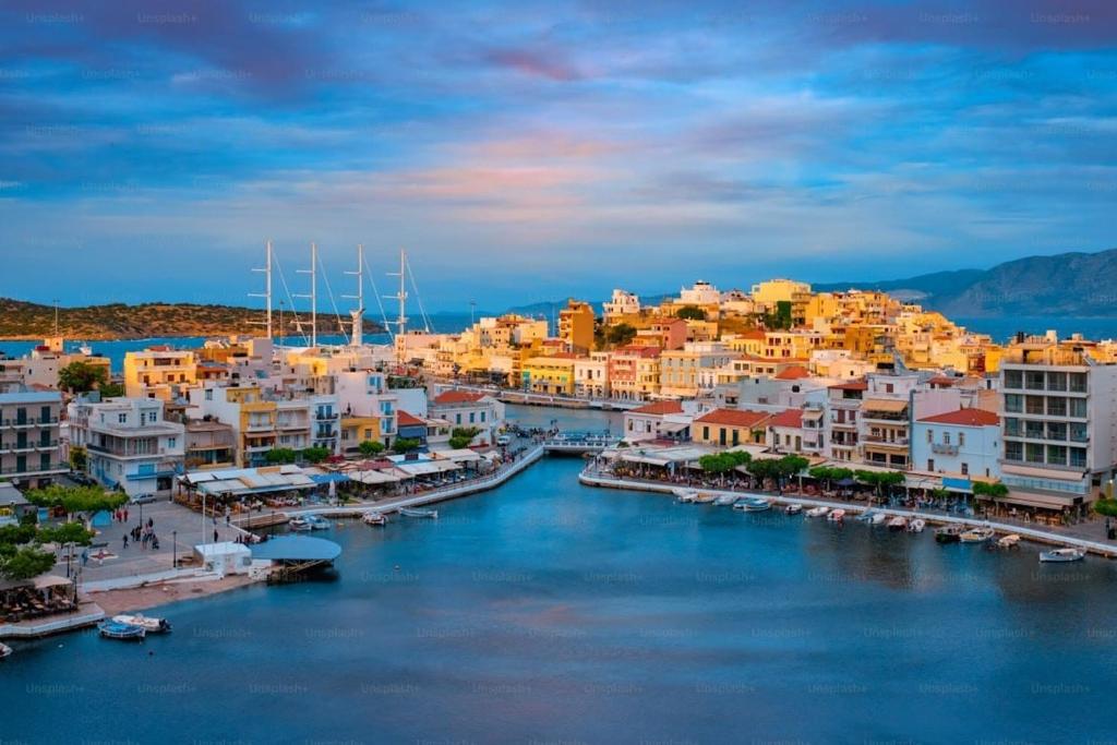 a city with a harbor with boats in the water at Characterful 2-Bed Home in Peaceful Town Near Agios Nikolaos in Neápolis