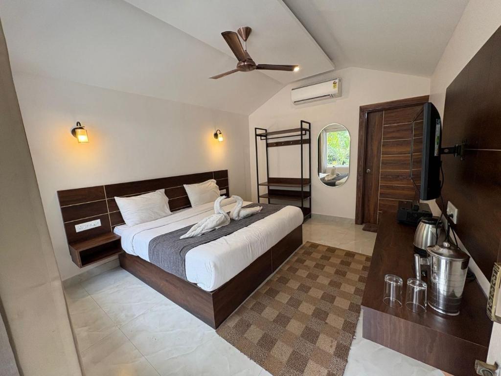 a bedroom with a bed and a ceiling fan at Glampers Resort Rishikesh at River Side in Rishīkesh