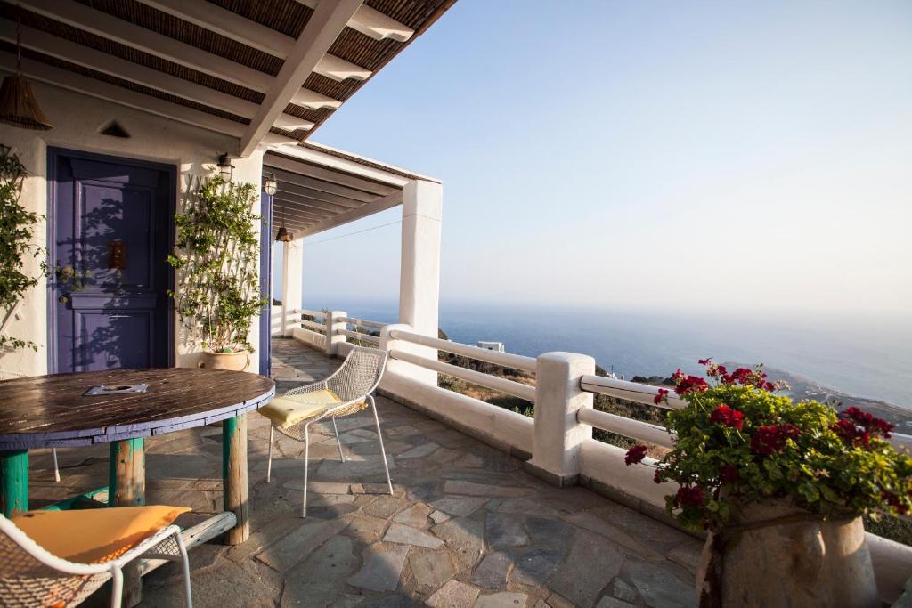 a balcony with a table and chairs and the ocean at Alia's sea view villa & studios in Apróvaton