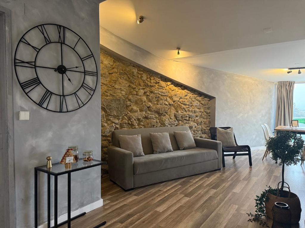 a living room with a couch and a large clock at Apartments Historic Center • Collection by Perpetual Relax in Braga