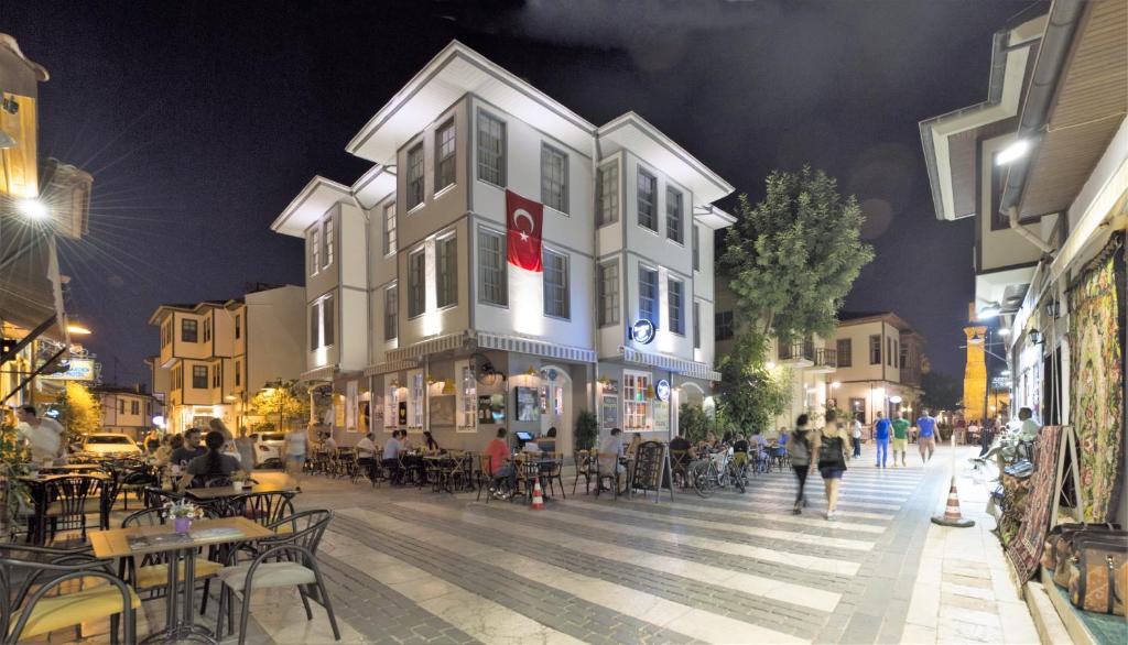 a city street at night with tables and chairs at Luna Hotel Kaleiçi in Antalya