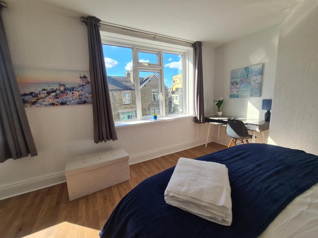 a bedroom with a bed and a large window at 3 Bed - Maisonette - Albert Road in Morecambe