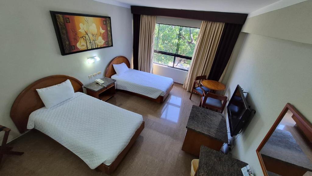 a hotel room with two beds and a television at Hotel Emperador in Valencia