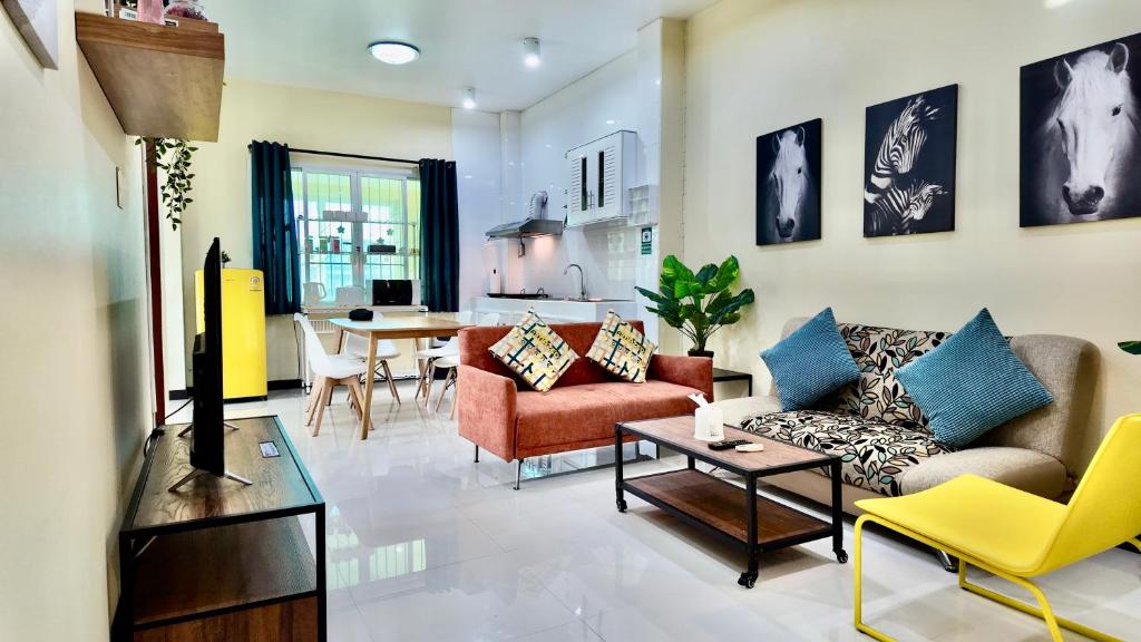 a living room with couches and a dining room at Phra Singh 64 Old City Center Stay in Chiang Mai