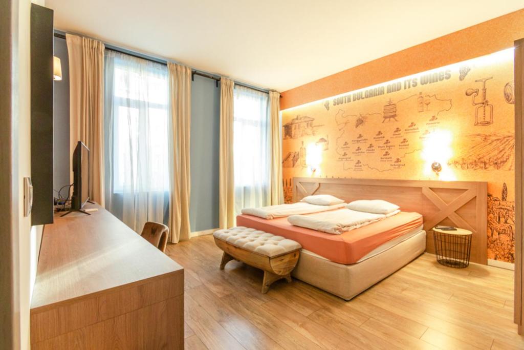 a bedroom with a bed and a tv in it at 1 BR Wine Journey in Sofia