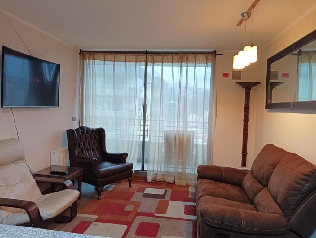 a living room with a couch and a chair at Viña del Mar Department in Viña del Mar