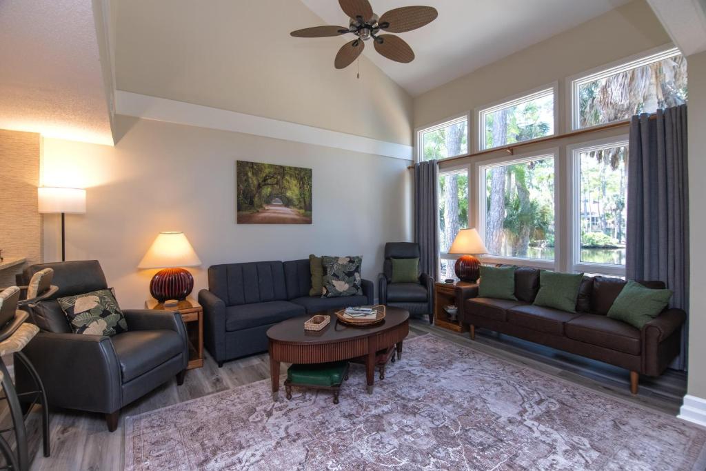 a living room with couches and a table at 493 Egrets Pointe - Dove's Nest in Edisto Island