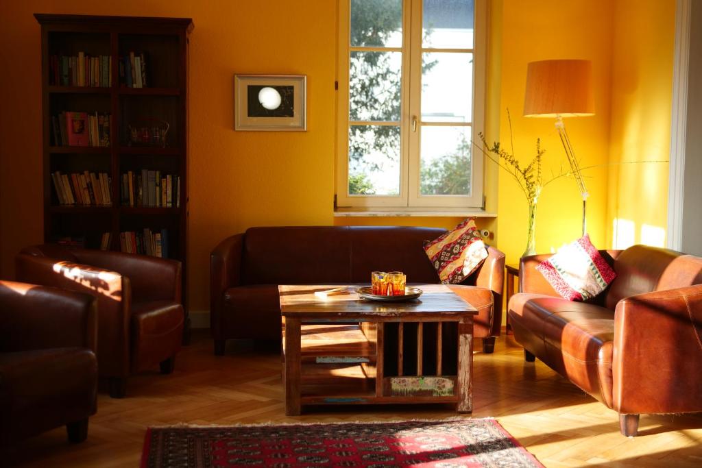 a living room with couches and a coffee table at Villa Art Residence Überlingen in Überlingen