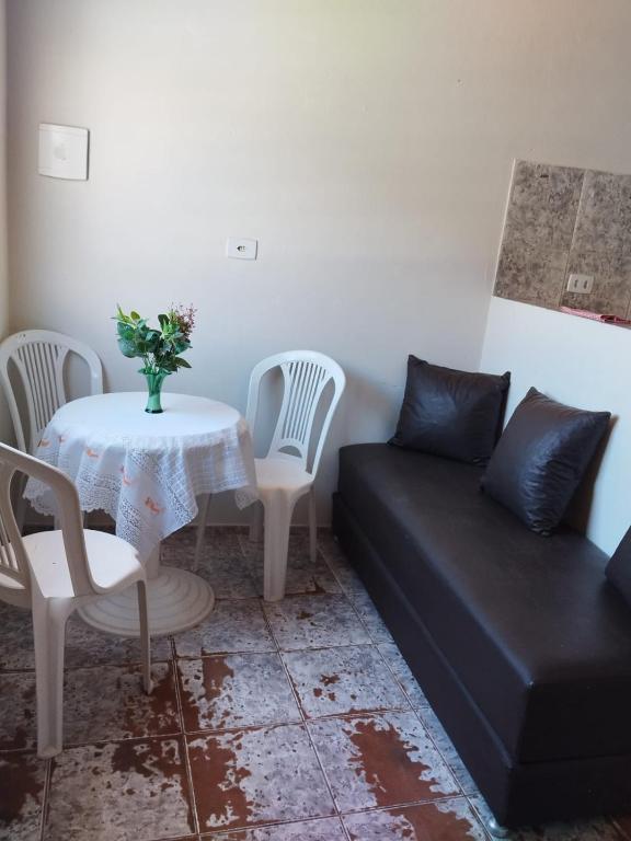 a living room with a table and a couch at Flat Carnaval de Olinda in Olinda