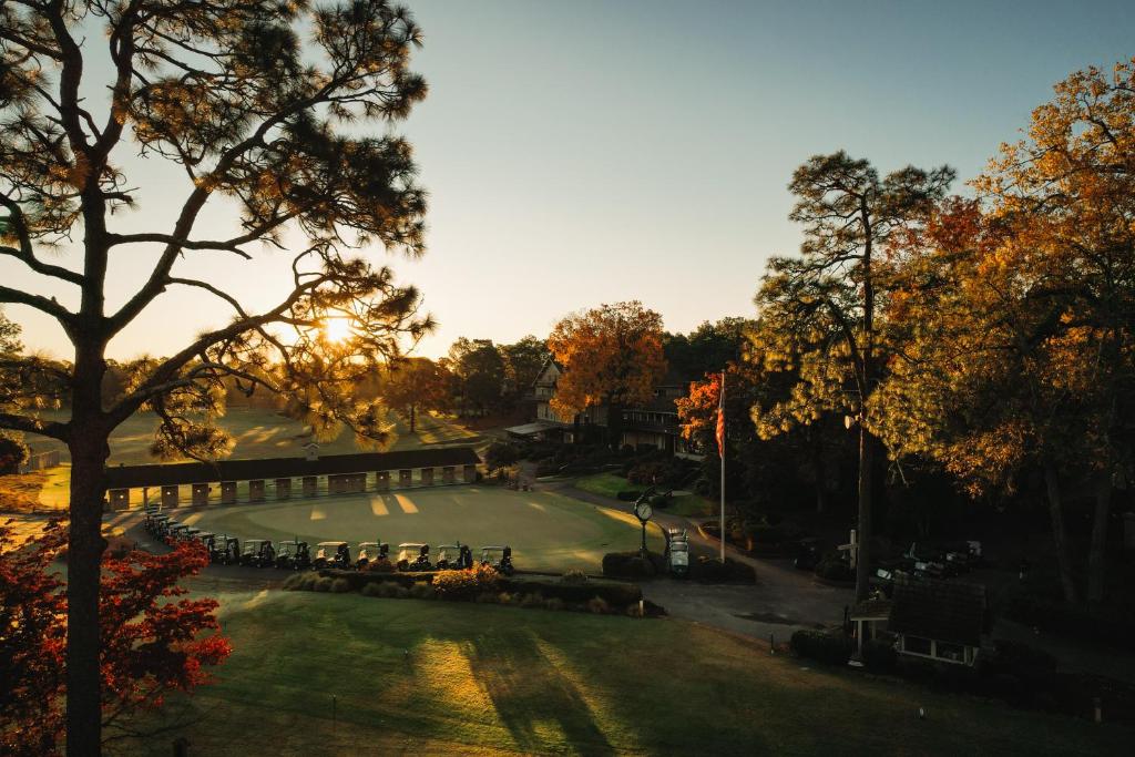 a view of a park with the sun setting at Pine Needles Lodge in Southern Pines
